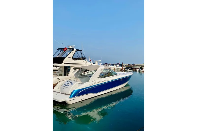 Slide: The Image of 2006 Formula 400 Super Sport boat docked in a marina under clear blue skies. - 6