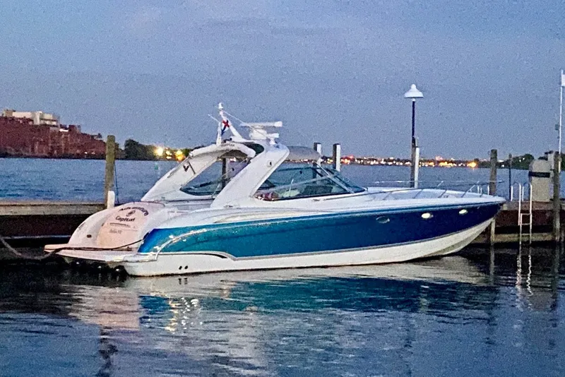 Slide: The Image of 2006 Formula 400 Super Sport boat docked at sunset, reflecting on calm water. - 3