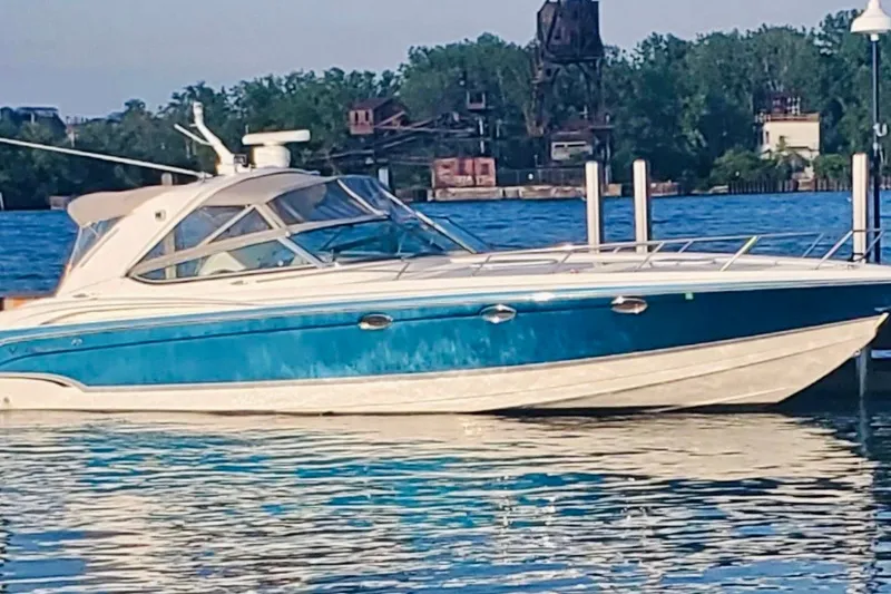 Slide: The Image of 2006 Formula 400 Super Sport boat docked on a sunny day by the water. - 1