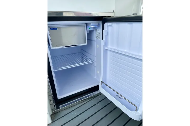 Slide: The Image of Open refrigerator on a 2006 Formula 400 Super Sport boat, showing empty interior shelves. - 20