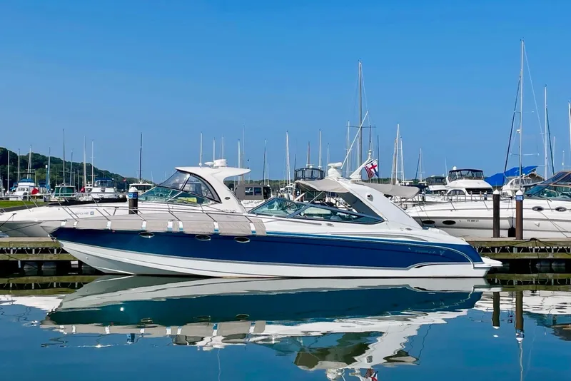 Slide: The Image of 2006 Formula 400 Super Sport yacht docked in a marina, reflecting on calm water. - 5