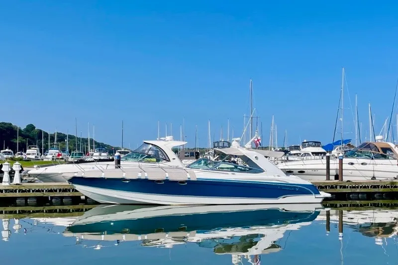 Slide: The Image of 2006 Formula 400 Super Sport yacht docked in a marina under clear blue skies. - 4