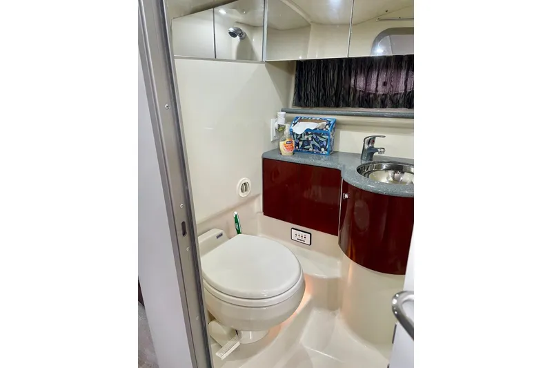 Slide: The Image of 2006 Formula 400 Super Sport yacht bathroom with toilet, sink, and storage cabinets. - 33