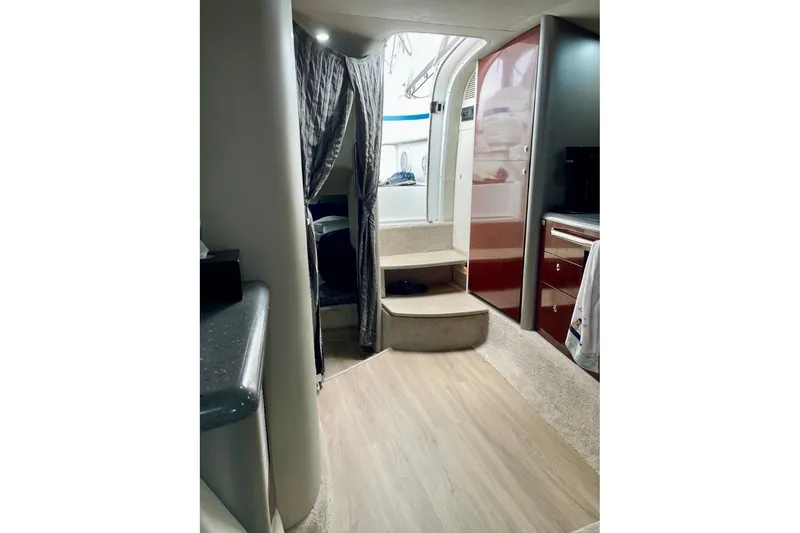 Slide: The Image of Interior of 2006 Formula 400 Super Sport boat, featuring stairs and modern cabinetry. - 23