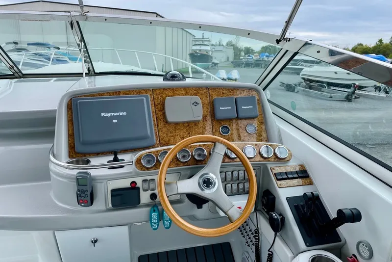 Slide: The Image of 2006 Formula 400 Super Sport boat dashboard with Raymarine navigation system and wooden steering wheel. - 15