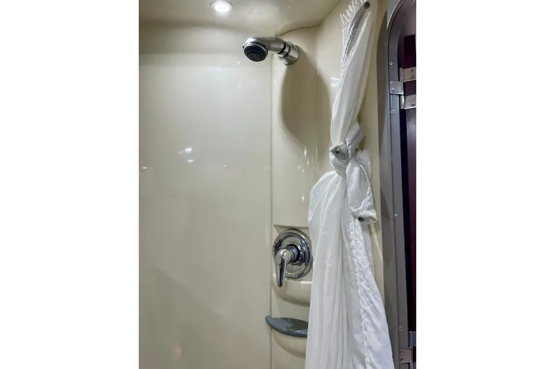 Slide: The Image of Shower area in 2006 Formula 400 Super Sport boat, featuring a curtain and chrome fixtures. - 34