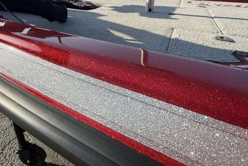 Slide: The Image of 2022 Phoenix 921 Elite boat with sparkling red and silver finish on deck. - 24
