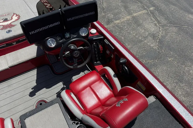 Slide: The Image of Red interior of 2022 Phoenix 921 Elite boat with dual Humminbird displays. - 22