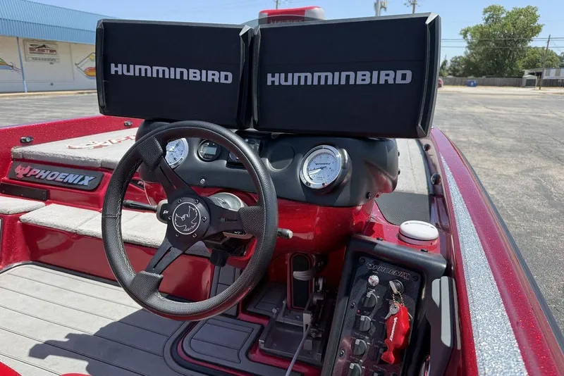 Slide: The Image of 2022 Phoenix 921 Elite boat dashboard with dual Humminbird displays and steering wheel. - 15