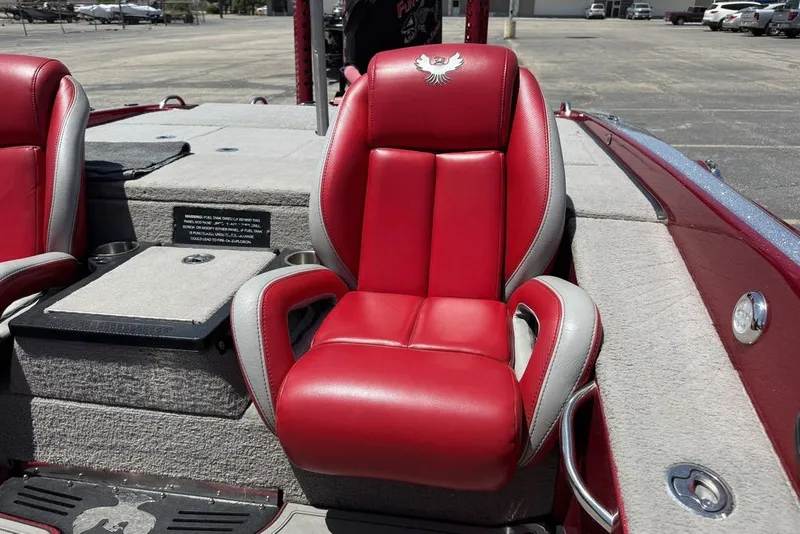 Slide: The Image of Red and gray seat in 2022 Phoenix 921 Elite boat, parked outdoors. - 23