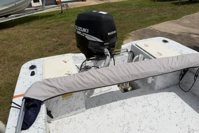 Slide: The Image of 2003 Southern Skimmer 2170 Skiff with Suzuki outboard motor on grassy area. - 15