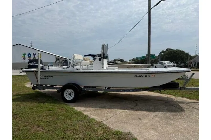 The Image of 2003 Southern Skimmer 2170 SKIFF boat on trailer, parked outdoors. - 1