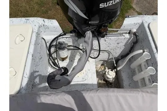 Slide: The Image of 2003 Southern Skimmer 2170 SKIFF boat engine area with Suzuki motor and wiring. - 16