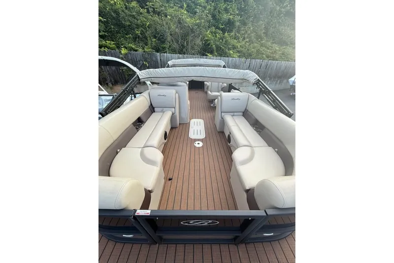Slide: The Image of 2024 Bentley Pontoons Legacy 243 DL Navigator with spacious seating and elegant design. - 4