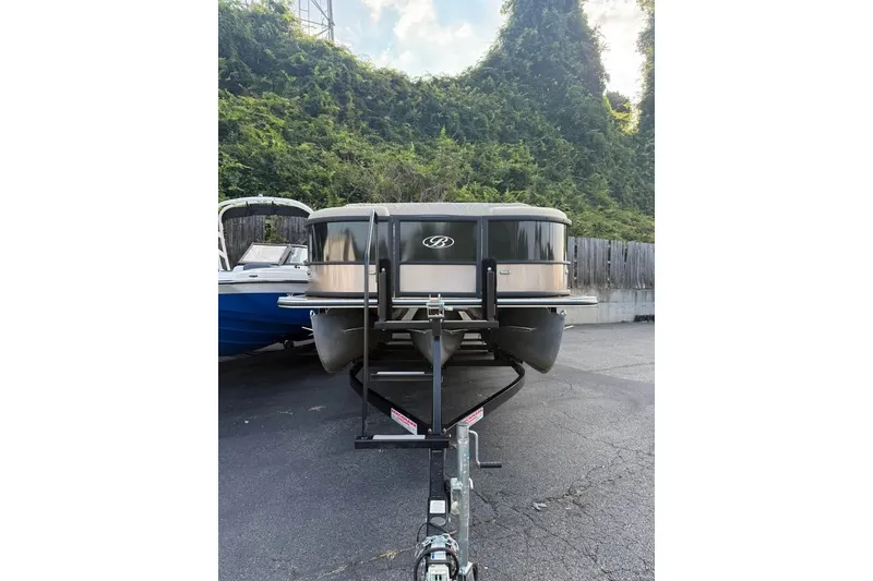 Slide: The Image of 2024 Bentley Pontoons Legacy 243 DL Navigator on trailer, parked outdoors. - 2