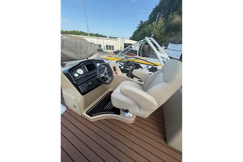 Slide: The Image of 2024 Bentley Pontoons Legacy 243 DL Navigator helm with plush captain's chair and controls. - 8