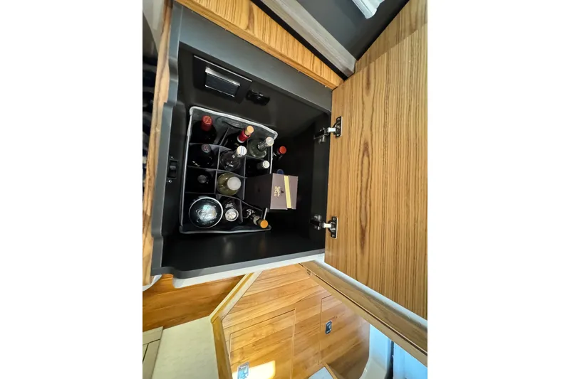 Slide: The Image of Cabinet with assorted bottles inside a 2023 Tiara Yachts 43 LE. - 48