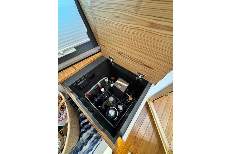 Slide: The Image of 2023 Tiara Yachts 43 LE interior storage with beverages and snacks. - 49