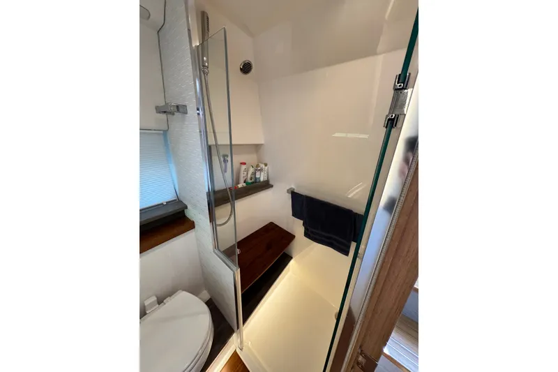 Slide: The Image of 2023 Tiara Yachts 43 LE bathroom with shower, glass door, and modern fixtures. - 46