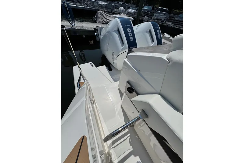 Slide: The Image of 2023 Tiara Yachts 43 LE with dual outboard engines docked at marina. - 32
