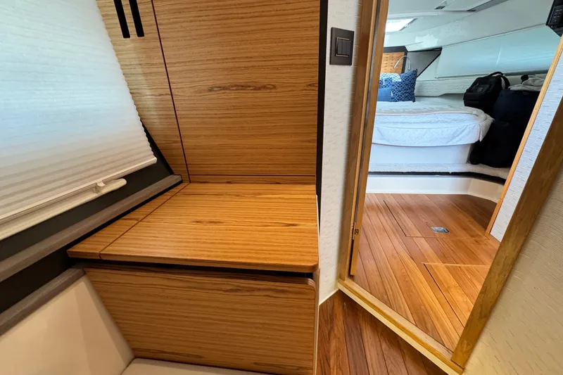 Slide: The Image of 2023 Tiara Yachts 43 LE interior with wooden cabinetry and cozy bedroom view. - 51