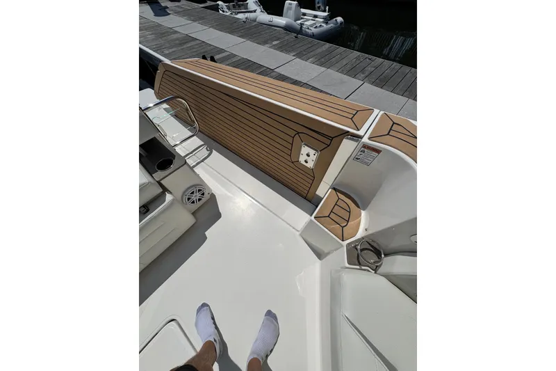 Slide: The Image of 2023 Tiara Yachts 43 LE deck with teak flooring and seating area. - 29
