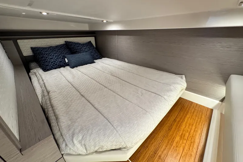 Slide: The Image of Luxurious cabin interior of 2023 Tiara Yachts 43 LE with cozy bedding and modern design. - 53