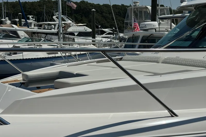 Slide: The Image of 2023 Tiara Yachts 43 LE docked among other boats, showcasing sleek design and luxury features. - 28