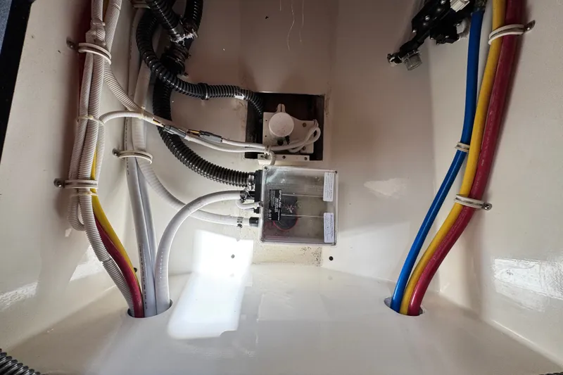 Slide: The Image of 2023 Tiara Yachts 43 LE engine compartment with colorful wiring and components. - 40