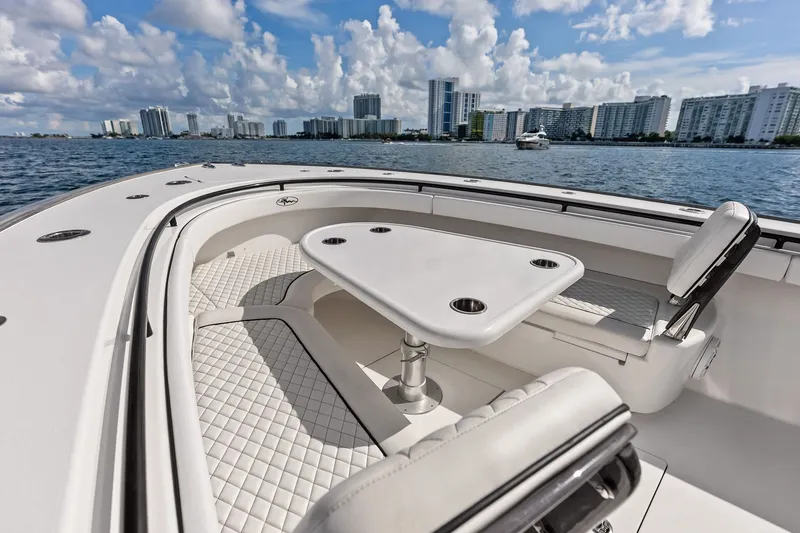 Slide: The Image of Luxurious 2022 Valhalla V-41 boat interior with seating and table, city skyline in background. - 63