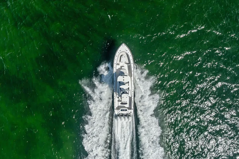 Slide: The Image of Aerial view of 2022 Valhalla V-41 boat cruising through vibrant green waters. - 18