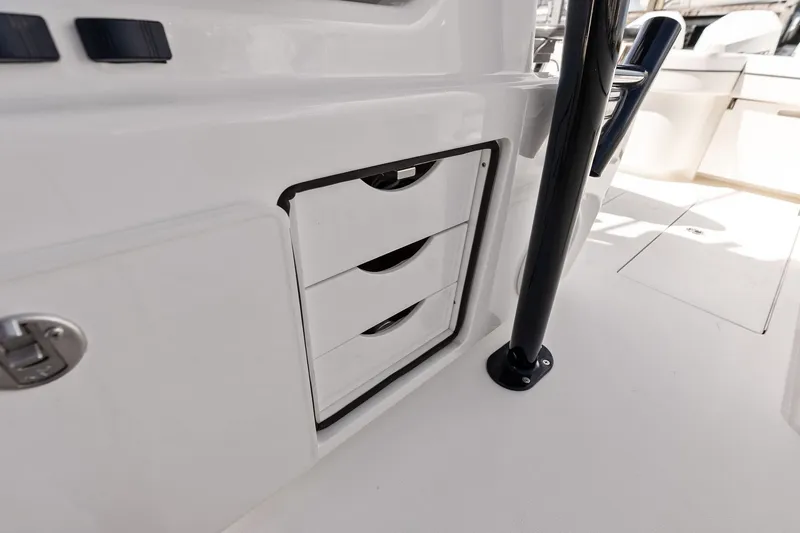 Slide: The Image of Interior storage drawers on 2022 Valhalla V-41 boat, featuring sleek white design. - 32