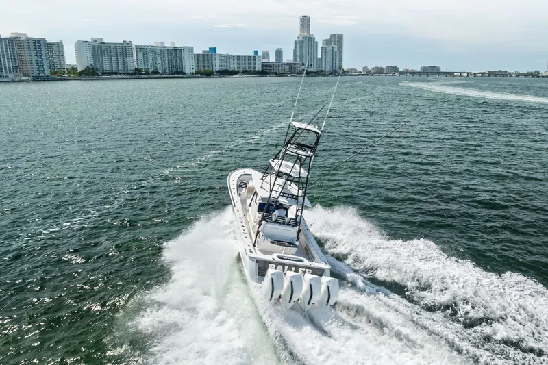 Slide: The Image of Valhalla V-41 boat cruising in open water near city skyline, 2022 model. - 20