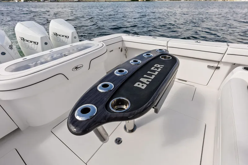 Slide: The Image of 2022 Valhalla V-41 boat deck with custom "BALLER" table and powerful engines. - 27