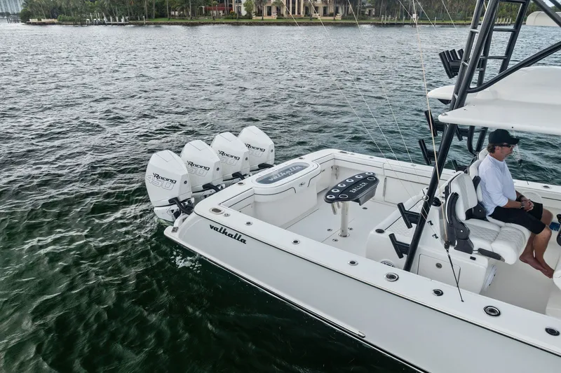 Slide: The Image of 2022 Valhalla V-41 boat with triple outboard engines on a calm waterway. - 9