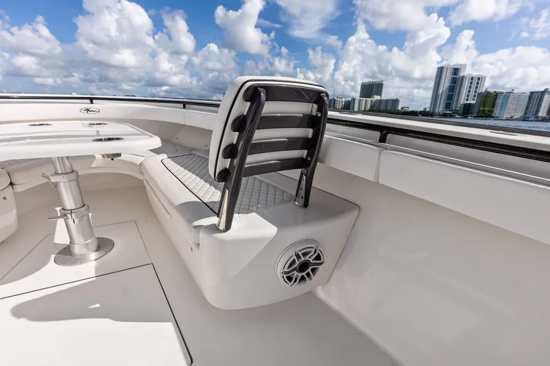 Slide: The Image of 2022 Valhalla V-41 boat interior with seating and table, city skyline in background. - 59