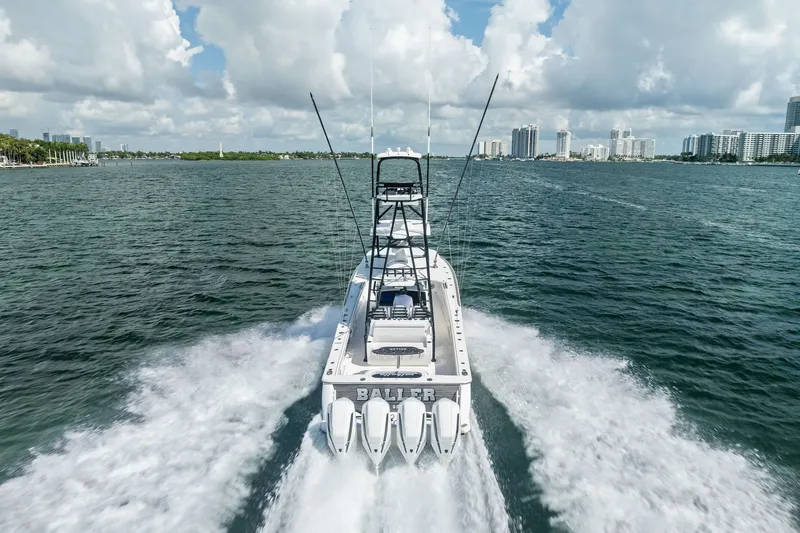 Slide: The Image of 2022 Valhalla V-41 boat cruising on open water with city skyline in background. - 17