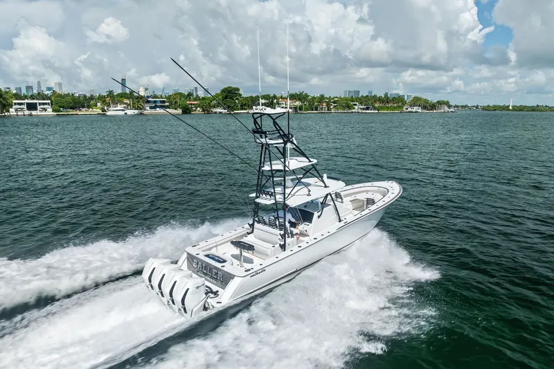 Slide: The Image of 2022 Valhalla V-41 boat cruising on a scenic waterway under a cloudy sky. - 16