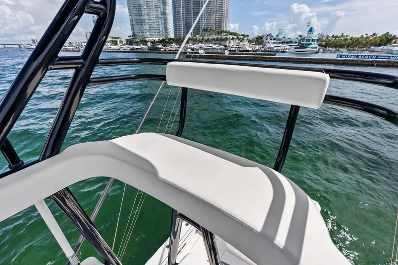 Slide: The Image of 2022 Valhalla V-41 boat interior with white seating, overlooking Miami Beach marina. - 55