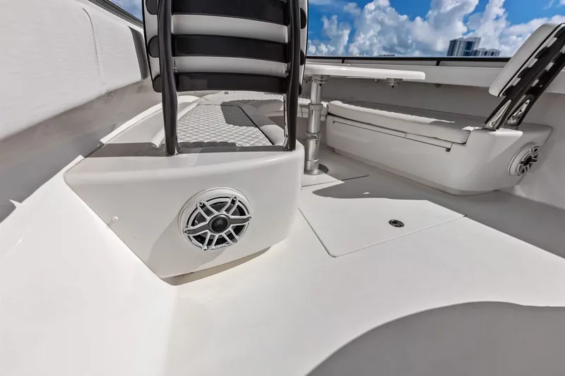 Slide: The Image of 2022 Valhalla V-41 boat interior with seating and speaker, under a blue sky. - 60