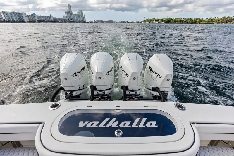 Slide: The Image of 2022 Valhalla V-41 boat with four powerful outboard engines cruising on water. - 25