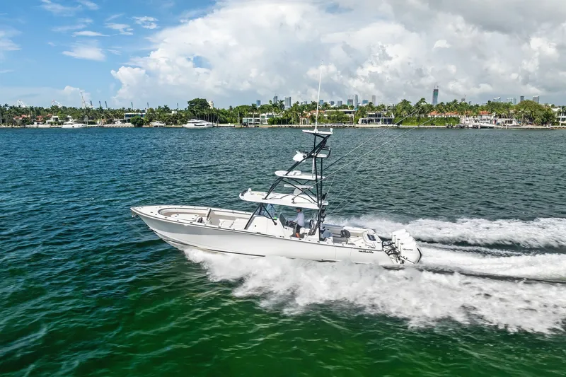 Slide: The Image of 2022 Valhalla V-41 boat cruising on a sunny day near a coastal city. - 15