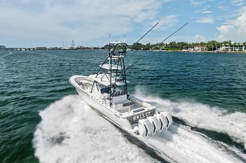 Slide: The Image of 2022 Valhalla V-41 boat cruising on open water with four engines. - 14