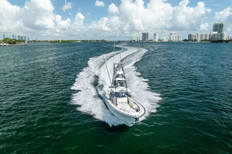 Slide: The Image of 2022 Valhalla V-41 boat cruising on a sunny day in a coastal cityscape. - 22