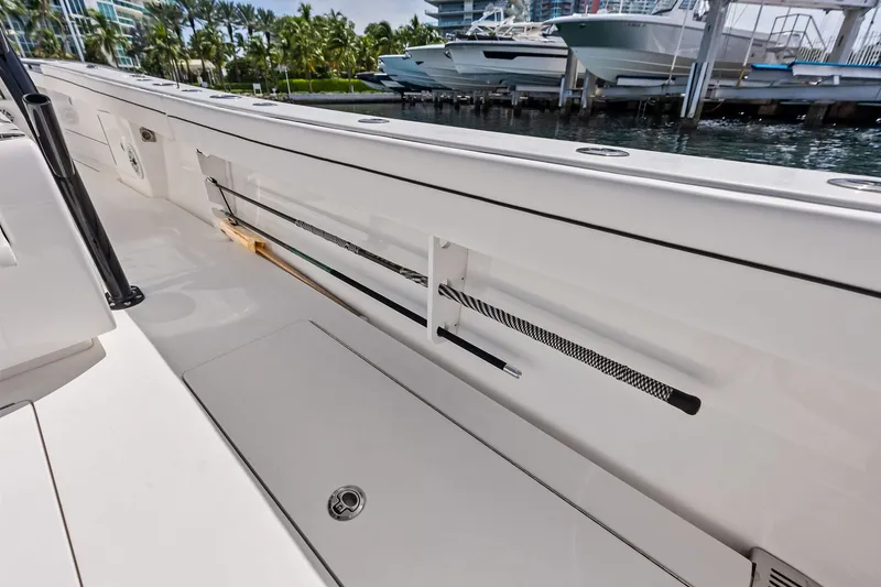 Slide: The Image of 2022 Valhalla V-41 boat interior with rod storage, docked near water. - 33