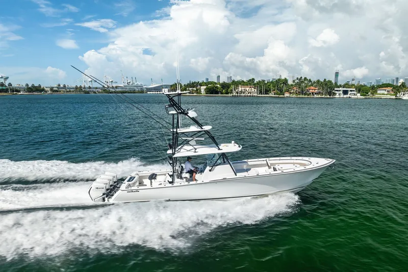 Slide: The Image of 2022 Valhalla V-41 boat cruising on a sunny day near a coastal cityscape. - 1