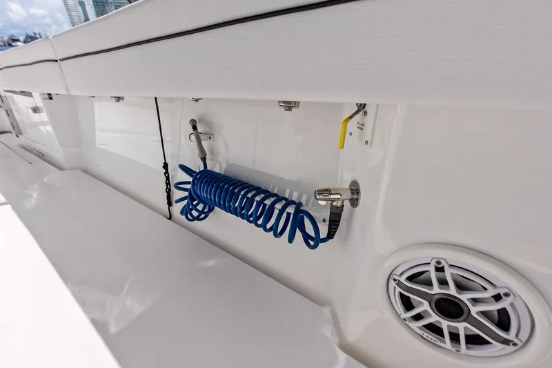 Slide: The Image of 2022 Valhalla V-41 boat deck with coiled blue hose and speaker. - 31