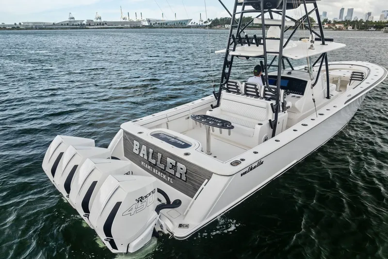 Slide: The Image of 2022 Valhalla V-41 boat with quad engines on open water, Miami Beach backdrop. - 8