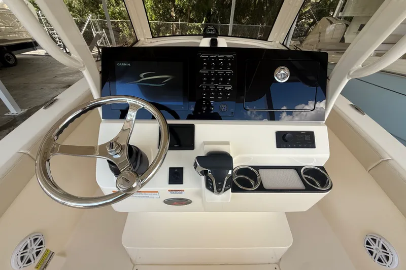 Slide: The Image of Steering console of 2027 Scout 240 XSF boat with modern controls and display. - 8