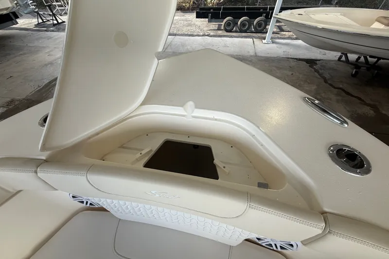 Slide: The Image of 2027 Scout 240 XSF boat with open storage compartment and sleek design. - 4